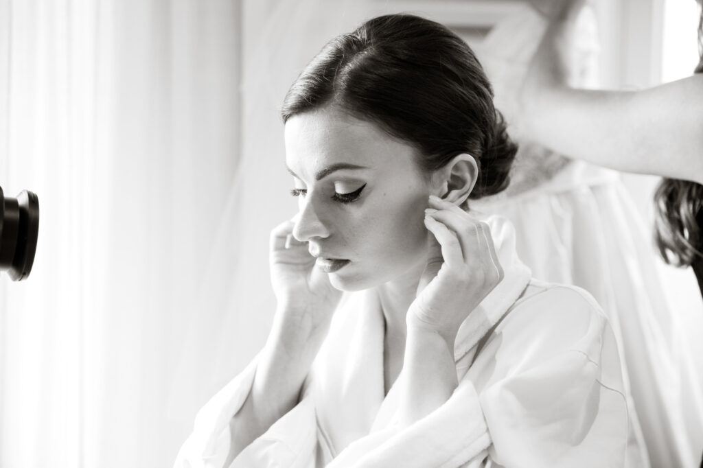 bride fixing earrings