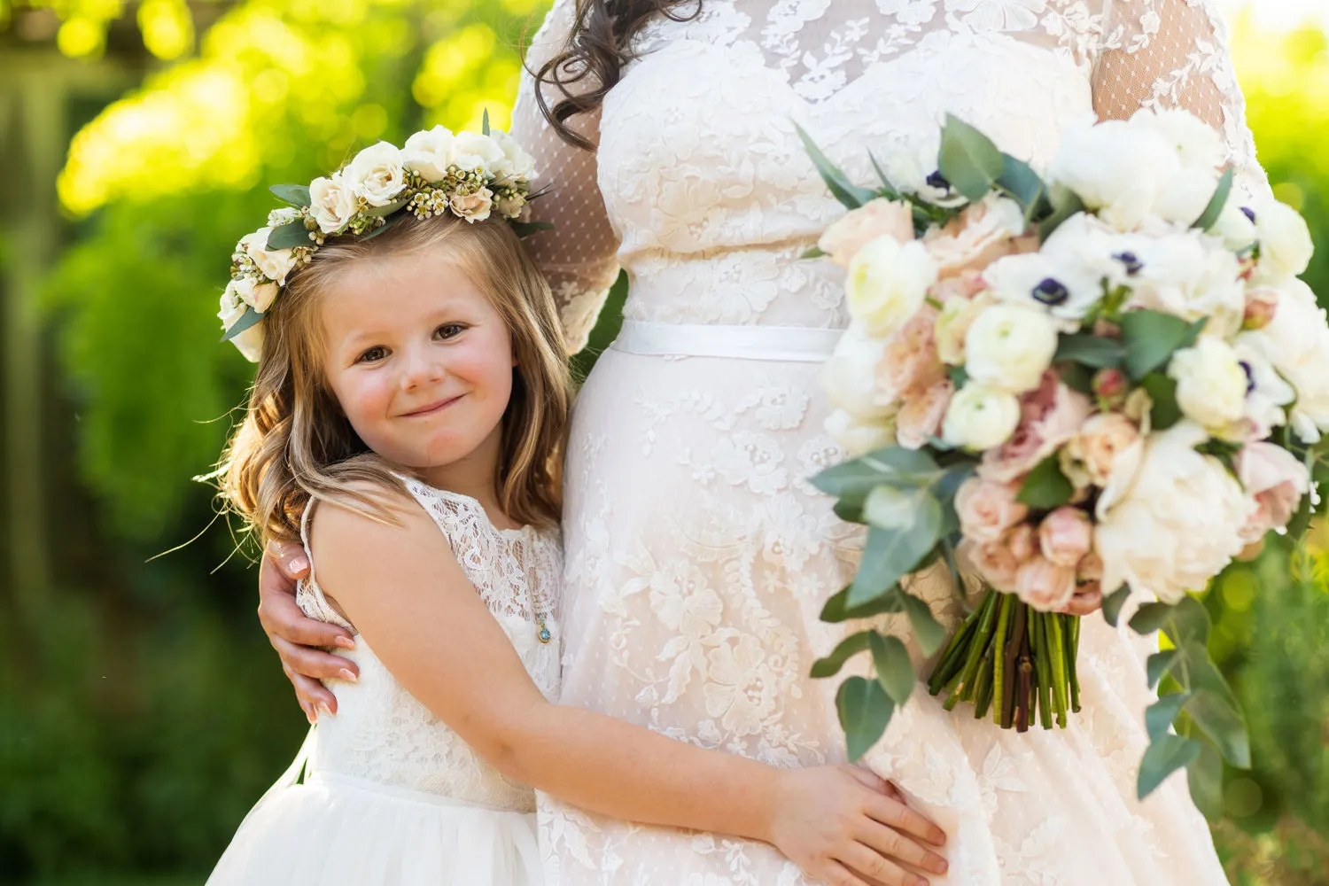 florer girl hugging bride