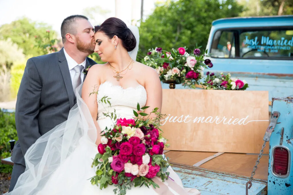 groom and bride on vintage truck