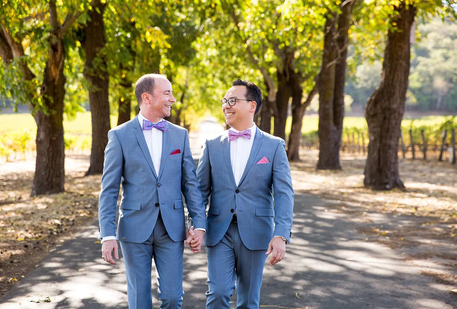 couple walking in tree lined road