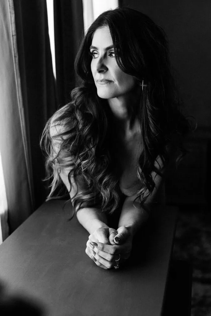 boudoir headshot of women looking out window