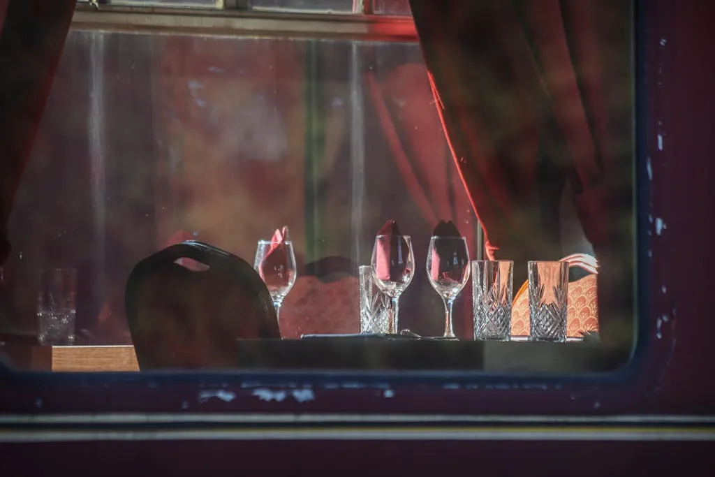 Sophisticated table setting with crystal glassware in a vintage train car.